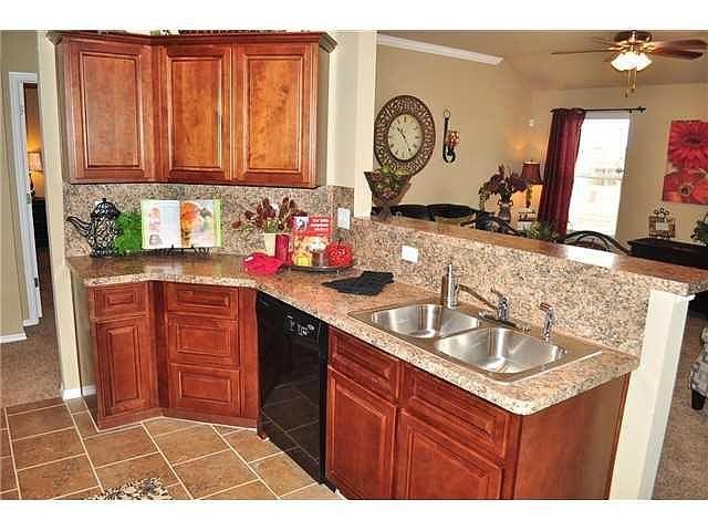 Open kitchen with wood cabinetry and a breakfast bar